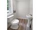 Powder room features a pedestal sink, new commode, and wood-look flooring at 156 Page Pl, Canton, GA 30114