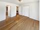 Bedroom with hardwood floors, closet space, and open doorway at 156 Page Pl, Canton, GA 30114