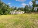 Charming one-story home with a long driveway and two-car garage surrounded by lush green lawns and trees at 156 Page Pl, Canton, GA 30114