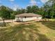 Ranch-style home with light exterior, attached garage, stone patio with fire pit, and beautiful landscaping at 156 Page Pl, Canton, GA 30114