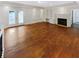 Spacious living room with hardwood floors, fireplace, built-in shelving, and french doors to the outside at 156 Page Pl, Canton, GA 30114
