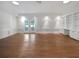 Spacious living room showcasing a built in bookcase, French doors and wood floors at 156 Page Pl, Canton, GA 30114