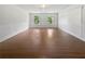 Bright living room featuring wood floors, fresh paint and lots of natural light from two windows at 156 Page Pl, Canton, GA 30114