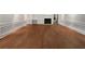 Spacious living room featuring detailed wainscoting, hardwood floors, a fireplace, and custom built-in shelving at 156 Page Pl, Canton, GA 30114