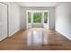 Bright bedroom features a bay window, hardwood floors, closet, and ample natural light at 156 Page Pl, Canton, GA 30114