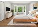 Serene main bedroom boasts a bay window, closet, light wood floors, and modern furnishings at 156 Page Pl, Canton, GA 30114