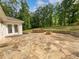 An outdoor stone patio offers an elegant space to enjoy nature and the warmth of a stone fire pit at 156 Page Pl, Canton, GA 30114