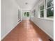 Bright sunroom featuring tile floors, windows, and access to the backyard and trees at 156 Page Pl, Canton, GA 30114
