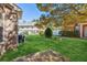 Landscaped backyard featuring a lawn, brick wall and patio at 2297 Elmbridge Rd, Buford, GA 30519