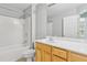 Bathroom featuring a shower-tub combo and vanity with wooden cabinets at 2297 Elmbridge Rd, Buford, GA 30519