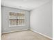 Bright bedroom with a window offering natural light and neutral carpeting at 2297 Elmbridge Rd, Buford, GA 30519