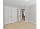 Bedroom featuring carpeted floor, closet, and an adjoining doorway at 2297 Elmbridge Rd, Buford, GA 30519