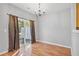 Dining area featuring hardwood floors, a chandelier, natural light, and sliding glass door at 2297 Elmbridge Rd, Buford, GA 30519