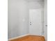 Bright entryway featuring white door, wood floor, neutral paint, and white trim at 2297 Elmbridge Rd, Buford, GA 30519