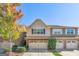 Charming townhome with two-car garage and well-maintained landscaping, offering a welcoming curb appeal at 2297 Elmbridge Rd, Buford, GA 30519