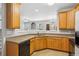 Kitchen has wood cabinets, gray walls and an opening to the living room at 2297 Elmbridge Rd, Buford, GA 30519