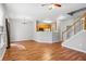 Open-concept living space with view of the kitchen, stairs and hardwood flooring at 2297 Elmbridge Rd, Buford, GA 30519