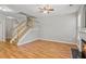 Open concept living room, stairs, and wood floors, showcasing the bright, airy layout at 2297 Elmbridge Rd, Buford, GA 30519