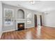 Bright living room featuring a fireplace, hardwood floors, a chandelier, and natural light at 2297 Elmbridge Rd, Buford, GA 30519