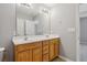 Main bath with double sinks and wood cabinets at 2297 Elmbridge Rd, Buford, GA 30519
