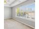 Main bedroom with large windows, ceiling fan and neutral gray walls at 2297 Elmbridge Rd, Buford, GA 30519