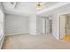 Main bedroom with ceiling fan, lots of space and a hallway to other bedrooms at 2297 Elmbridge Rd, Buford, GA 30519