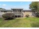 Brick home with screened-in porch, stairs to yard, and a lush lawn at 4063 Elmscourt Dr, Stone Mountain, GA 30083