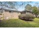 Large, grassy backyard featuring a screened-in porch attached to a brick house at 4063 Elmscourt Dr, Stone Mountain, GA 30083