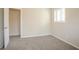 A carpeted bedroom is displayed, featuring neutral walls and open doorway at 4063 Elmscourt Dr, Stone Mountain, GA 30083