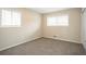 This carpeted bedroom features two windows, neutral walls, and ample natural light at 4063 Elmscourt Dr, Stone Mountain, GA 30083