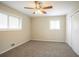 This carpeted bedroom includes a ceiling fan, windows, and a closet at 4063 Elmscourt Dr, Stone Mountain, GA 30083