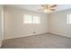 This bedroom features neutral walls, carpet, a ceiling fan, and multiple windows at 4063 Elmscourt Dr, Stone Mountain, GA 30083