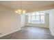 This dining room has hardwood-style floors, a modern light fixture, and a large picture window at 4063 Elmscourt Dr, Stone Mountain, GA 30083