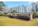 Brick ranch home with mature landscaping and lawn at 4063 Elmscourt Dr, Stone Mountain, GA 30083