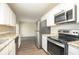 Updated kitchen with granite counters, stainless appliances, hardwood flooring, and ample cabinet space at 4063 Elmscourt Dr, Stone Mountain, GA 30083