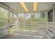 Enclosed back porch featuring white wood railings and a serene view of the surrounding greenery at 4063 Elmscourt Dr, Stone Mountain, GA 30083