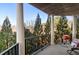 Large balcony with columns, black metal railing and a great view of lush trees and blue sky at 200 River Vista Dr # 502, Atlanta, GA 30339