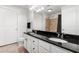 Bathroom boasts dual sinks, granite counters, and sleek fixtures at 200 River Vista Dr # 502, Atlanta, GA 30339