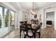 Dining room with brick accent wall, modern light fixture, and sliding glass doors to outdoor seating area at 200 River Vista Dr # 502, Atlanta, GA 30339