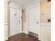 Hallway with two white doors, one showing a unit number, with neutral-colored walls and dark wood floors at 200 River Vista Dr # 502, Atlanta, GA 30339