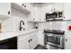 Bright white kitchen with stainless steel oven and modern black fixtures at 200 River Vista Dr # 502, Atlanta, GA 30339