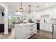 Bright kitchen featuring white cabinets, subway tile backsplash, and a center island with marble countertop at 200 River Vista Dr # 502, Atlanta, GA 30339