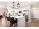 Kitchen with island, modern light fixtures, stainless appliances and white cabinets at 200 River Vista Dr # 502, Atlanta, GA 30339
