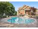 Community pool surrounded by trees and lounge chairs at 200 River Vista Dr # 502, Atlanta, GA 30339