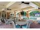 Outdoor pool area with covered seating, tables, stone accents, and ceiling fans at 200 River Vista Dr # 502, Atlanta, GA 30339