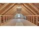 Spacious attic with exposed beams, bright sunlight and ample room for storage or renovation at 223 Ivy Creek Dr, Loganville, GA 30052