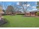Large, well-maintained backyard with healthy green grass, storage shed, and privacy fence at 223 Ivy Creek Dr, Loganville, GA 30052