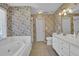 This bathroom has a soaking tub and dual sinks at 223 Ivy Creek Dr, Loganville, GA 30052