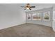 A cozy bedroom featuring carpeted floors and large, sunlit windows at 223 Ivy Creek Dr, Loganville, GA 30052