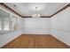 Well-lit dining room with hardwood floors, white walls, and a chandelier at 223 Ivy Creek Dr, Loganville, GA 30052